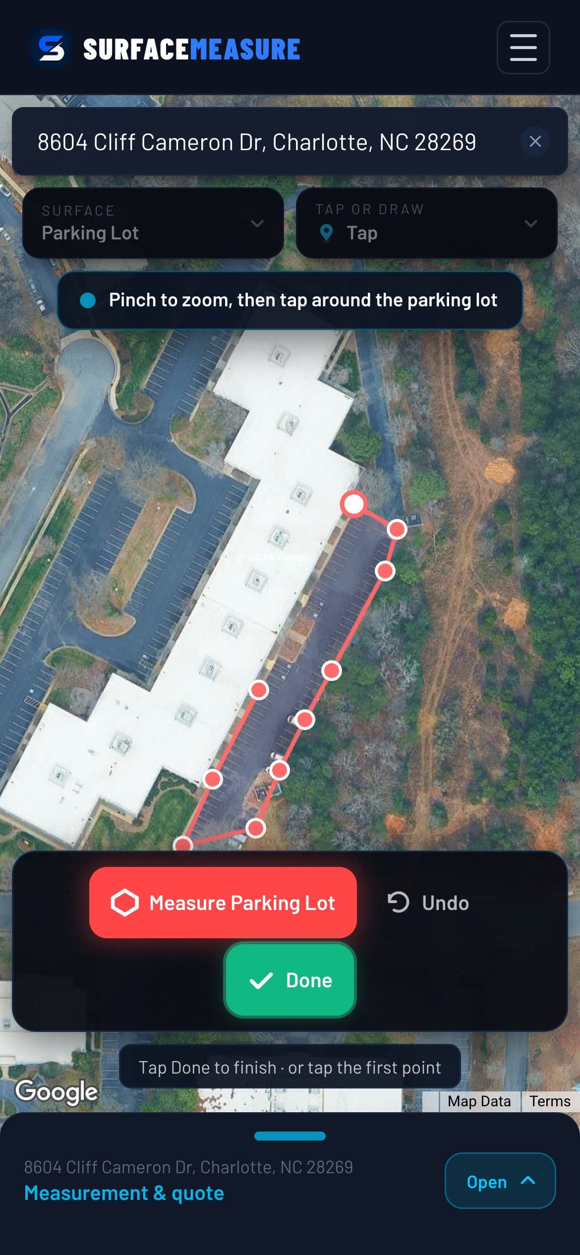 A commercial parking lot being traced corner by corner along its curb on satellite imagery in SurfaceMeasure