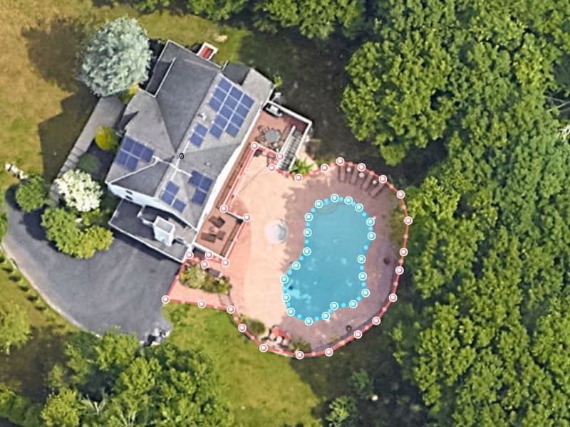 A pool deck traced in SurfaceMeasure on satellite imagery, with the pool outlined separately inside it so its area can be subtracted from the deck